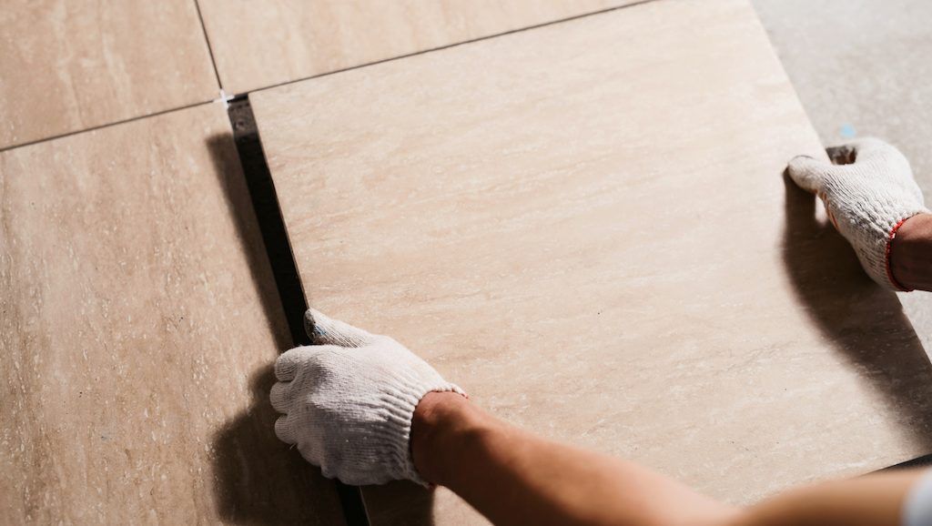 tiler laying bathroom flooring