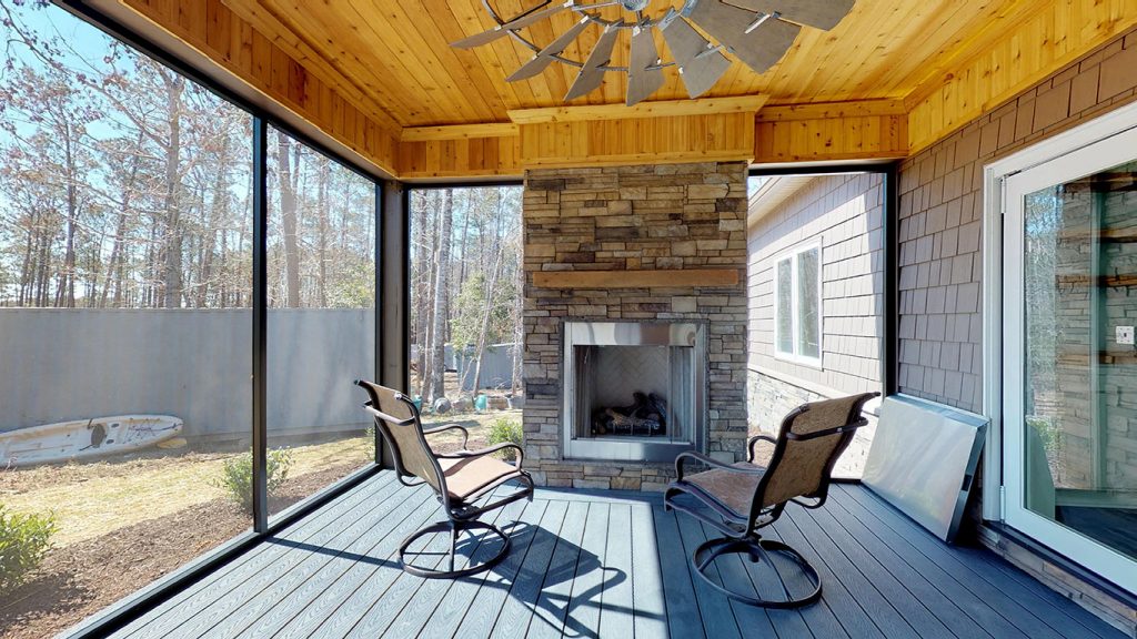 custom screened porch with fireplace