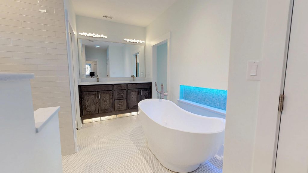 custom bathroom with tub and accent lighting