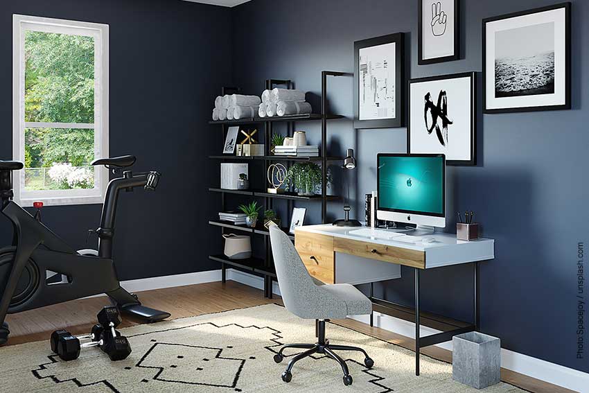 Dark blue walls make this home office/gym the perfect room for the latest trends