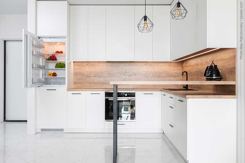 Trendy kitchen with reclaimed wood backsplash