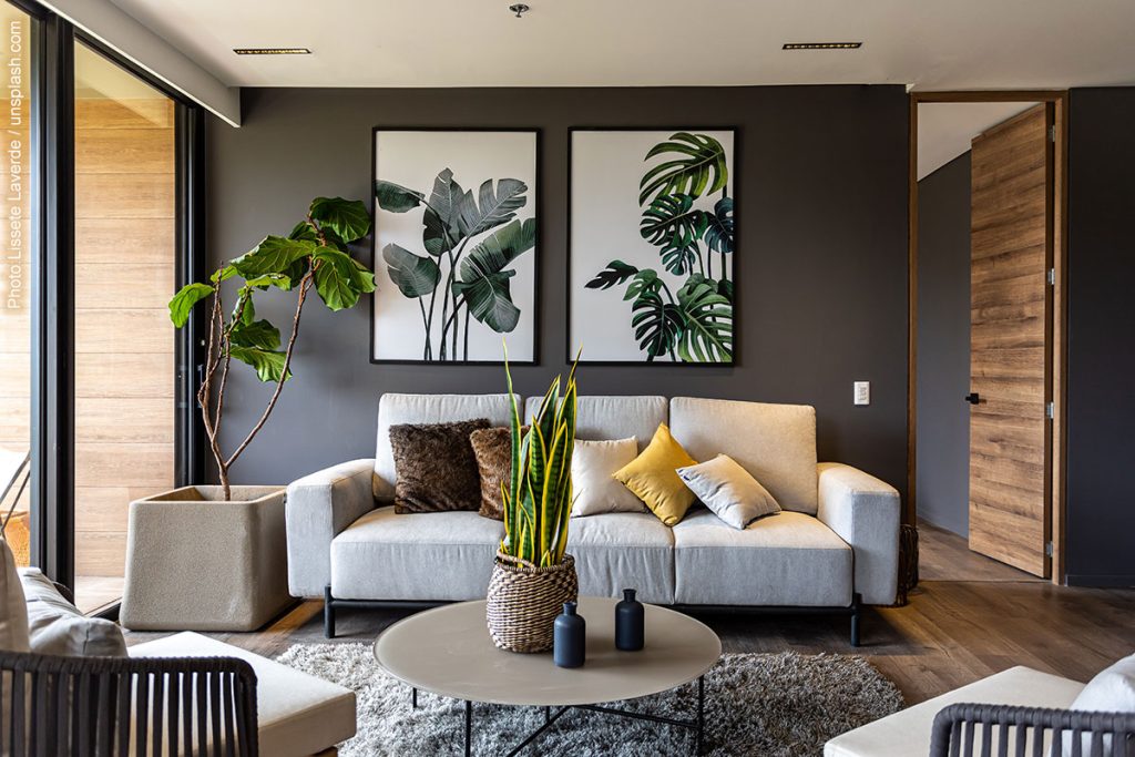 Biophillic living room example with earth tones, wood, and plants.