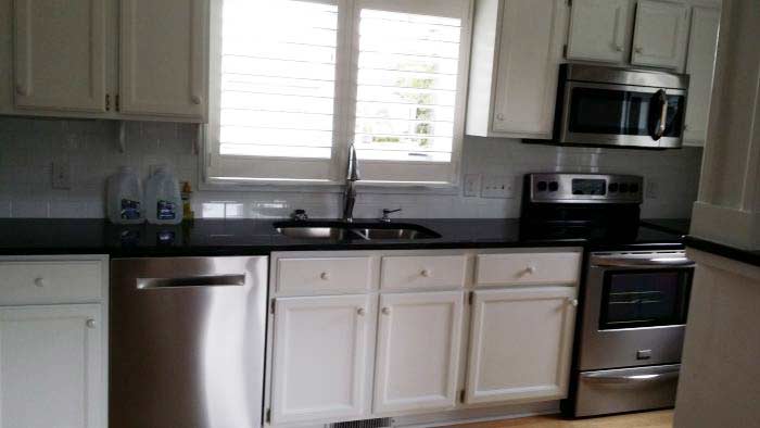 Black countertop with white cabinets kitchen renovation